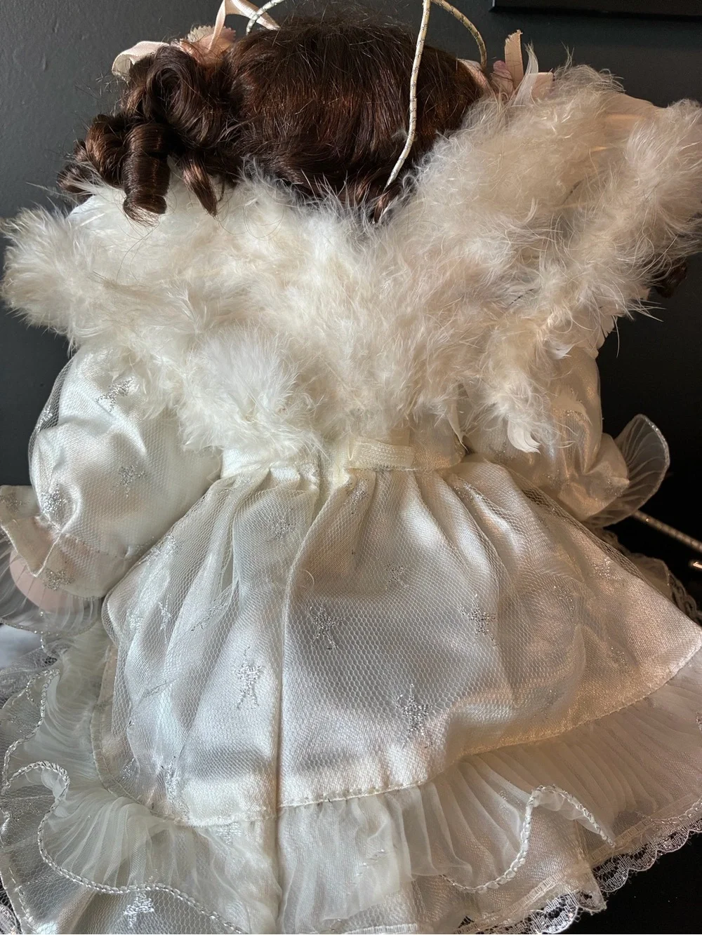Vintage porcelain doll holding wand and wearing halo